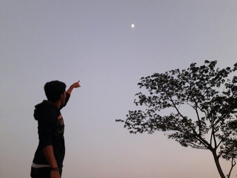 a man is flying a kite in the sky